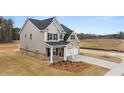 Two-story house with gray siding, brick accents, and a two-car garage at 13550 Whitman Se Ln, Covington, GA 30014