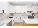 Modern kitchen with white shaker cabinets, quartz countertops, and stainless steel appliances at 361 Fort Ne St, Marietta, GA 30060