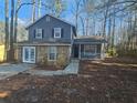 Gray house with stone accents and a spacious yard at 1037 Forest Path, Stone Mountain, GA 30088