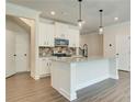 Spacious kitchen with white cabinets, granite countertops, and stainless steel appliances at 262 Depot Landing Rd, Auburn, GA 30011