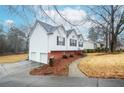 Side view of a white house with a two-car garage and walkway at 2832 Fieldstone Se Dr, Conyers, GA 30013