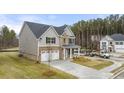 Two-story home with brick and siding, gray trim, and a two-car garage at 13218 E Tolstoy Se Drs, Covington, GA 30014