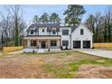Charming two-story white home with a covered porch and black garage doors at 467 Concord Sw Rd, Smyrna, GA 30082