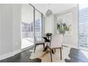 Cozy dining area with modern chandelier and floor to ceiling windows at 20 10Th Nw St # 901, Atlanta, GA 30309