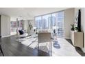 Open-concept living space featuring hardwood floors, modern decor, and city views at 20 10Th Nw St # 901, Atlanta, GA 30309