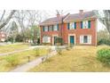 Brick front exterior of charming townhome with landscaped yard and walkway at 6136 Winfield Ct, Tucker, GA 30084