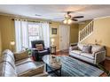 Bright living room featuring hardwood floors, large windows, and ample seating at 6136 Winfield Ct, Tucker, GA 30084