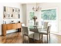 Bright dining room with glass table, chairs, and hardwood floors at 255 Grogans Lake Pt, Atlanta, GA 30350