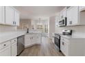 Modern kitchen with white cabinets, stainless steel appliances, and quartz countertops at 2839 Suttonwood Way, Buford, GA 30519