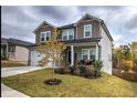 Exterior view of a two-story home featuring a welcoming front porch and lush landscaping in a peaceful neighborhood at 419 Murphy Ave, Canton, GA 30114