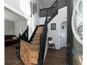 Two-story foyer with hardwood floors and a wooden staircase at 107 Vestry Walk, Douglasville, GA 30134