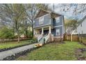 Two-story craftsman home with a charming front porch and landscaped yard at 107 Howard Ne St, Atlanta, GA 30317