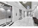 Elegant lobby with marble floors, mirrored walls, and sophisticated lighting at 325 E Paces Ferry Rd # 2003, Atlanta, GA 30305