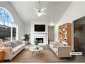 Virtually staged living room with fireplace and large windows at 3430 Laurel Springs Cv, Villa Rica, GA 30180