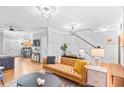 Spacious living room featuring a leather couch and a view into the kitchen at 665 Windsor Sw St, Atlanta, GA 30310