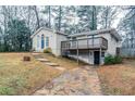 Tan house with blue door, deck, and paved driveway at 3743 Turner Heights Dr, Decatur, GA 30032
