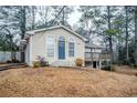 Tan house with blue door and deck in wooded area at 3743 Turner Heights Dr, Decatur, GA 30032