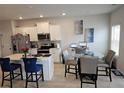 Bright kitchen features an island, stainless steel appliances, and an adjacent dining area at 2502 Polaris Sw Way, Atlanta, GA 30331