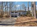 Split-level home features two-car garage and driveway leading up to the home with mature trees at 190 Hembree Forest Cir, Roswell, GA 30076