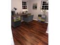 Home office space with hardwood floors, a modern desk, a comfortable chair, and natural light at 2500 Celina Ct, Morrow, GA 30260