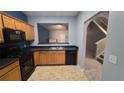 Kitchen with oak cabinets, black appliances, and a breakfast bar at 2025 Austin Park Cir, Decatur, GA 30032