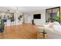 Open-concept living space featuring a kitchen, wood floors, and a balcony at 3481 Ne Lakeside Dr # 1508, Atlanta, GA 30326