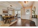 Bright dining room features a rustic wooden table, bench seating, and stylish light fixture at 194 Friars Head Dr, Suwanee, GA 30024