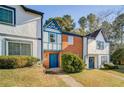 Brick front townhouse with blue door and landscaping at 3614 Main Station Sw Dr, Marietta, GA 30008