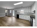 Bright kitchen with white cabinets and vinyl flooring at 165 Riverbend Dr, Covington, GA 30014