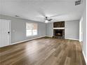 Spacious living room with fireplace and wood-look floors at 165 Riverbend Dr, Covington, GA 30014