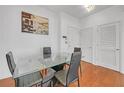 Bright dining area with glass table and four black chairs at 3040 Peachtree Rd # 614, Atlanta, GA 30305