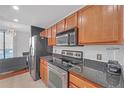 Modern kitchen with stainless steel appliances and wood cabinets at 3040 Peachtree Rd # 614, Atlanta, GA 30305