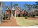 Two-story brick home featuring an elegant entrance and well-manicured lawn at 1105 River Laurel Dr, Suwanee, GA 30024