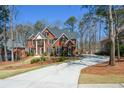 Two-story brick home with an attached garage and a well-maintained front yard at 1105 River Laurel Dr, Suwanee, GA 30024