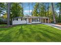 Newly renovated Ranch home with a modern front door and landscaped lawn at 1464 Sanden Ferry Dr, Decatur, GA 30033