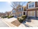 Street view of a modern townhome community with manicured landscaping and uniform architectural design at 1584 Richmond Se Dr, Mableton, GA 30126
