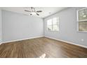 Bright bedroom featuring wood floors, ceiling fan, and large windows at 2056 Wildflower Way, Conyers, GA 30012