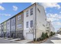 Row of townhouses featuring modern design and attached garages at 1074 Crest Se Cir, Atlanta, GA 30312