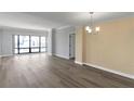 A brightly lit living room featuring hardwood floors, a large window and neutral paint at 3475 Oak Valley Ne Rd # 1930, Atlanta, GA 30326