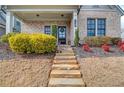 Inviting front entrance with stone steps leading to a charming porch and a beautifully decorated front door at 3000 Smyrna Grove Dr, Smyrna, GA 30082