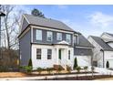 Two-story house with gray siding, white accents, and a green front door at 386 10Th Unit 57 St, Auburn, GA 30011
