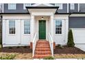 Brick steps leading to a charming green front door with white columns at 386 10Th Unit 57 St, Auburn, GA 30011