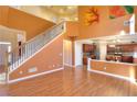 Two-story living room with hardwood floors and a fireplace at 1070 Blackwood Ct, Johns Creek, GA 30024