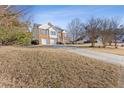 Two-story house with a driveway and landscaping, offering curb appeal at 135 Trelawney Pl, Covington, GA 30016
