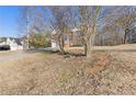 House exterior showcasing landscaping and a long driveway at 135 Trelawney Pl, Covington, GA 30016