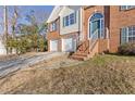 Front entrance with brick steps leading to a double-door entry at 135 Trelawney Pl, Covington, GA 30016