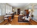 Bright home office featuring hardwood floors and built-in shelving at 2368 Peeler Rd, Dunwoody, GA 30338