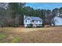 Two-story house with a large backyard and surrounding trees at 90 Greatwood Dr, White, GA 30184