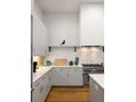 Updated kitchen featuring white subway tile backsplash, modern gray cabinets, and stainless steel appliances at 122 Gainey Ln, Chattahoochee Hills, GA 30268