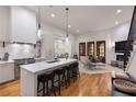 Modern open-concept kitchen with an island, bar stool seating, and stainless steel appliances at 122 Gainey Ln, Chattahoochee Hills, GA 30268